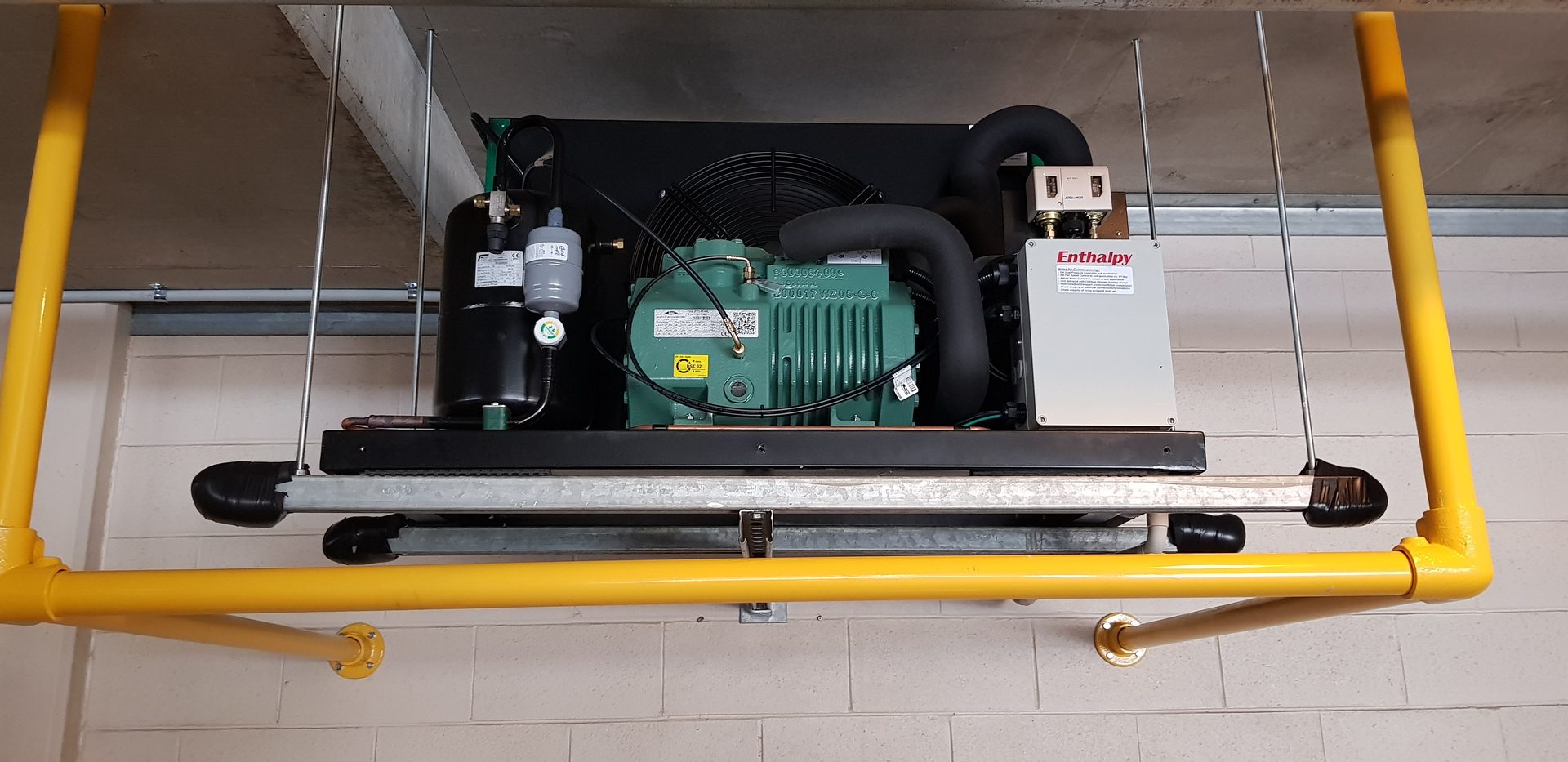 Enthalpy commercial refrigeration compressor and plant mounted on suspended frame