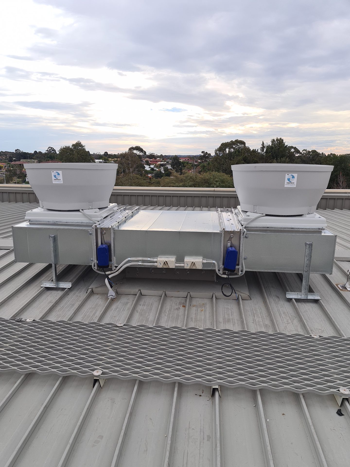 Fantech dual rooftop exhaust fans on galvanised ductwork